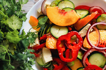 Salad of bell peppers, cucumbers, peaches, celery, red onions and sesame seeds. Vegan food and snacks. Clean eating, raw food, detox, plant based