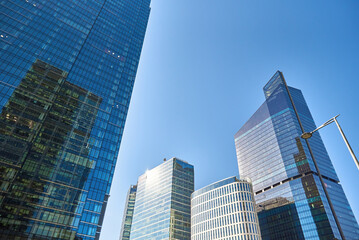 Administrative center in Warsaw, Business office buildings in downtown central district, Skyscrapers with glass facade against blue sky