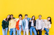 © Xavier Lorenzo - Young adult united group of multiracial happy friends leaning on yellow wall - Community and unity concept with diverse trendy teenage people smiling at camera