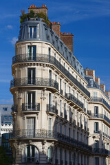 Wall Mural - The facade of traditional French house with typical balconies and windows. Paris.