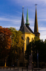 Wall Mural - Classic view of Notre-Dame Cathedral in Luxembourg with high spires and flag of country