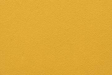 Colorful concrete wall, bright yellow vintage style of cement background paint with small texture details.