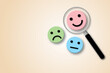 © Chitraporn - Magnifier focuses on smile face circle and pastel background. Concept of positive thinking, mental health assessment and world mental health day. copy space. illustration of 3d paper cut design style.
