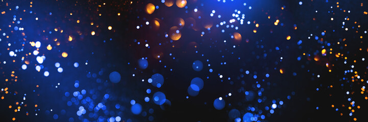 Wall Mural - golden abstract bokeh on dark blue background. holiday concept