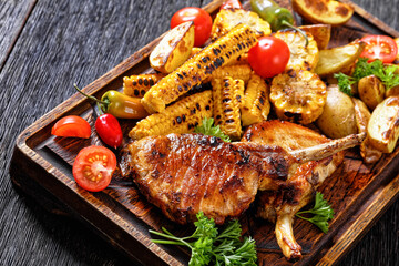 Sticker - bbq tomahawk pork chop with corn and potatoes