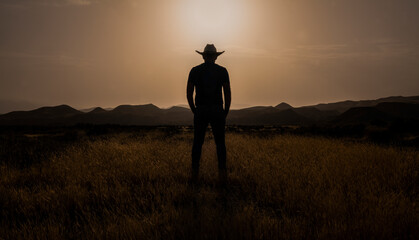 Silhouette of adult man standing on desert during sunset. Almeria, Spain