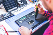 © Photocreo Bednarek - IT engineer technician repairing computer in electronics service shop