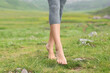 © Antonioguillem - Sportswoman feet walking on the grass in the mountain