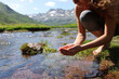 © Antonioguillem - Yogi cupping hands catching water from river in the mountain