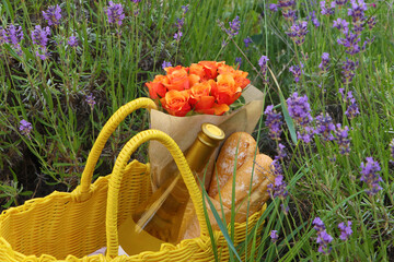 Canvas Print - Yellow wicker bag with beautiful roses, bottle of wine and baguettes in lavender field