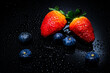 © Kittipan - Blueberries and Strawberries on black background, close-up. Selective Focus.