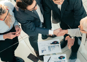 Poster - top view. business colleagues shake hands in agreement .