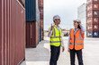 © Kawee - Caucasian business man and woman worker working in container terminal.