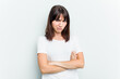 © Asier - Young caucasian woman isolated on white background frowning face in displeasure, keeps arms folded.