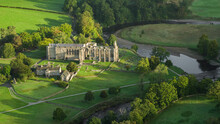 Early Morning Sunshine Illuminates Bolton Abbey In Wharfedale, North Yorkshire, England, Takes Its Name From The Ruins Of The 12th-century Augustinian Monastery Now Known As Bolton Priory