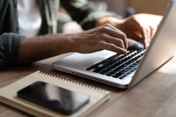 Hand typing message on keyboard laptop chatting friend search information form internet while working on computer