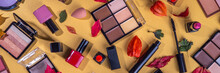 Autumn Make Up Set On Golden Table Background, With Autumn Leaves And Beauty Accessories. Various Makeup Professional Cosmetics - Shadows, Lipstick, Corrector, Mascara, Eyeliner, Bronzer, Blush