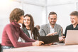 © yurolaitsalbert - group of business people working with a laptop in the Bank office
