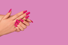 Female hands with pink nail design. Mate pink nail polish manicure. Female model hands with perfect pink manicure.