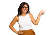 © Asier - Young Indian woman isolated on green chroma background smiling cheerfully pointing with forefinger away.