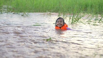 Wall Mural - Slow motion kids playing water flooding in rice field in countryside 