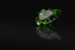 Heart cut emerald gemstone on black background with reflections and free space. 3D rendering