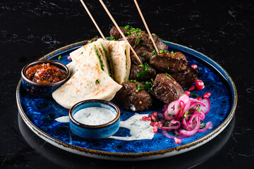 Wall Mural - Turkish and Arabic Traditional Ramadan mix kebab plate. Kebab adana, lamb and beef on lavash bread with sauce