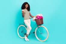 Full Length Portrait Of Adorable Lovely Girl Hold Telephone Cycling Fresh Wildflowers Isolated On Aquamarine Color Background