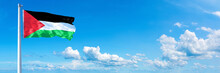 Palestine Flag Waving On A Blue Sky In Beautiful Clouds - Horizontal Banner