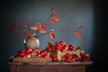 Wall Mural - red apples on old wooden table on background blue wall