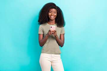 Wall Mural - Photo of cute adorable lady wear striped t-shirt communicating modern device isolated turquoise color background