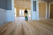 © ungvar - Carpenter grinding a wooden parquet floor by using floor sander in newly constructed house to ensure that it is smooth even