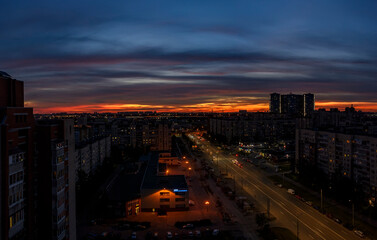 Bright summer sunset in the city taken from a tall building.