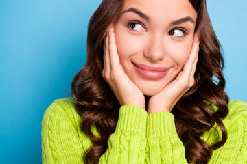 Sticker - Cropped close up photo of young pretty girl with wavy hairstyle palms on cheekbones look empty space isolated on blue color background