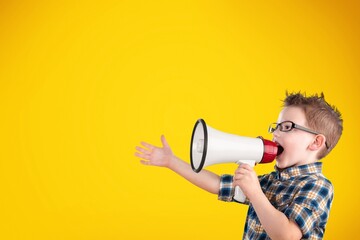 Portrait of young fun smart happy boy hold megaphone loudspeaker back to school concept.