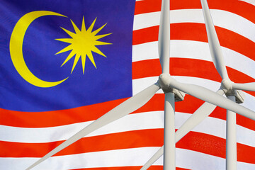 Two Wind Turbines for alternative energy on Malaysia flag background. Energy development and energy crisis. Eco power and Wind stations for renewable electric energy production in Malaysia