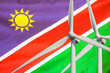 Wall Mural - Two Wind Turbines for alternative energy on Namibia flag background. Energy development and energy crisis. Eco power and Wind stations for renewable electric energy production in Namibia