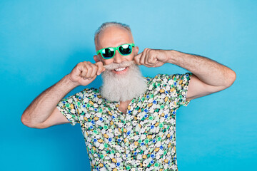 Wall Mural - Photo of old age pensioner senior grandfather toothy smile touch his mustache metrosexual wear sunglass isolated on bright blue color background