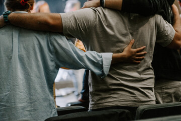 a group of christians pray to bless and pray for each other in church