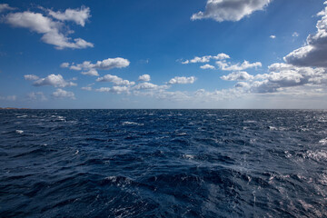Wall Mural - endless ocean with blue sky and some nice white clouds for composition