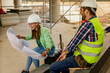 © DusanJelicic - Two happy civil engineer and maintenance engineer in protective vests and helmets working on a construction site