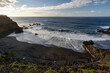 El Bollullo black sand beach (playa el bollullo) and its beautiful waves at sunset, one of the most wonderful beaches in Tenerife, Canary Islands, Spain.