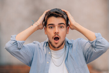 Poster - attractive young bearded caucasian man in the street with surprised expression