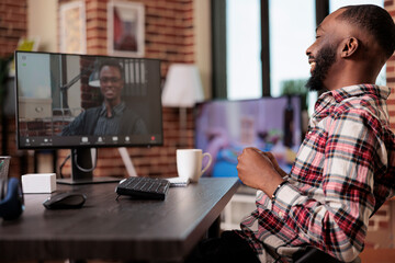 Wall Mural - young adult using online videocall meeting with employees on computer, talking on remote teleconfere