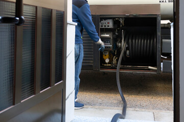 company  truck parked  front a house with hose in door for delivering home heating oil  for boilers