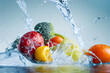 Fruits and vegetables splashing into clear water