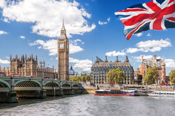 Wall Mural - Big Ben with bridge over Thames and flag of England against blue sky in London, England, UK