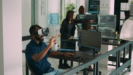 male app developer using virtual reality glasses to code new server interface, analyzing cloud infor