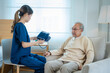 © visoot - Nurse caregiver with senior man using blood pressure tool at home or nursing home.