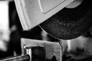 Selective focus on chop saw abrasive blade used for cutting metal.